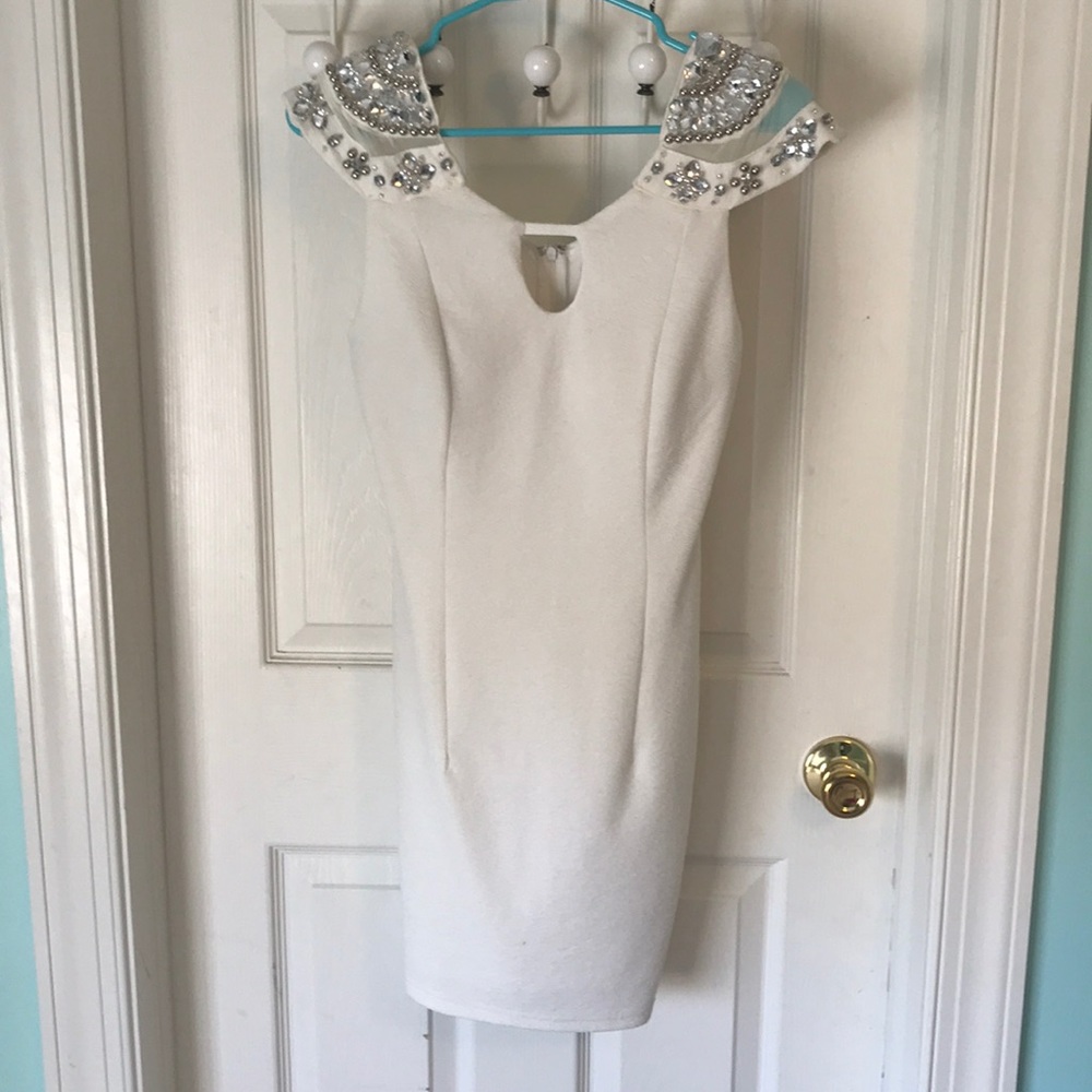 White formal dress with sequin embellishments.